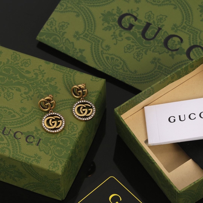 G*u*i earrings